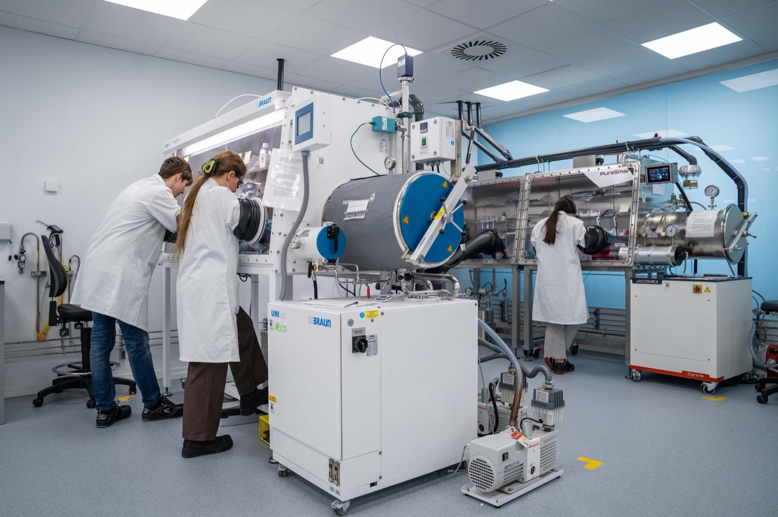 Researchers working with glovebox equipment